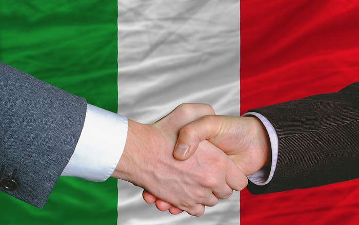 Business Handshake In Front of Italian Flag