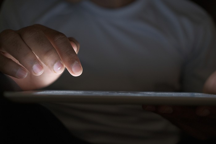 Man Using Tablet in the Dark