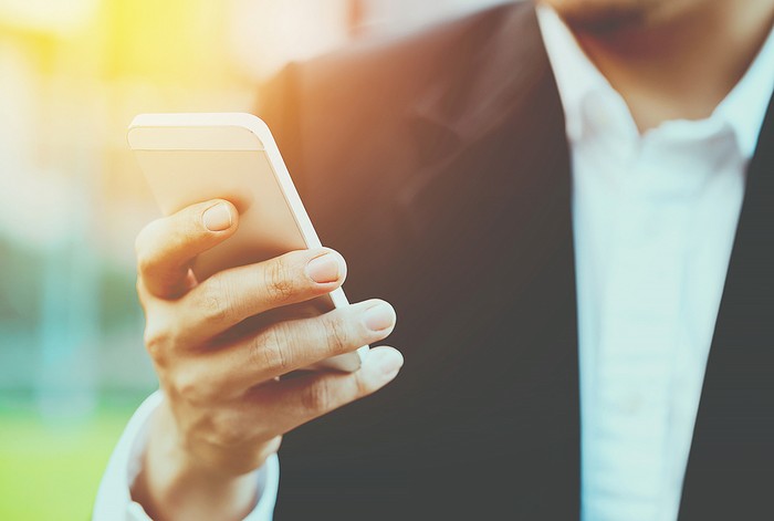Man Wearing Suit Holding Smartphone