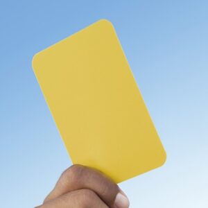 Hand Holding Yellow Card