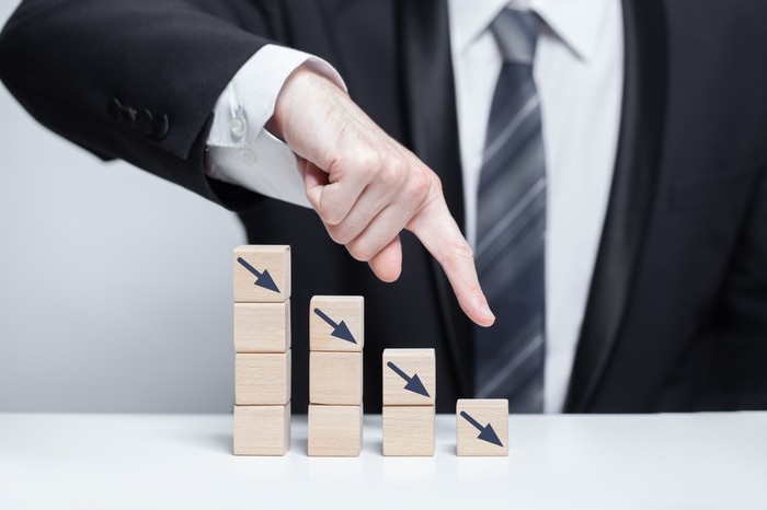 Businessman with Decreasing Wooden Blocks