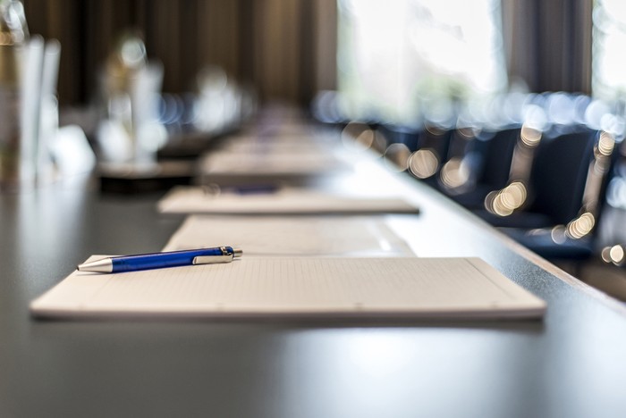 Blue Pen and Notepad in Conference Room