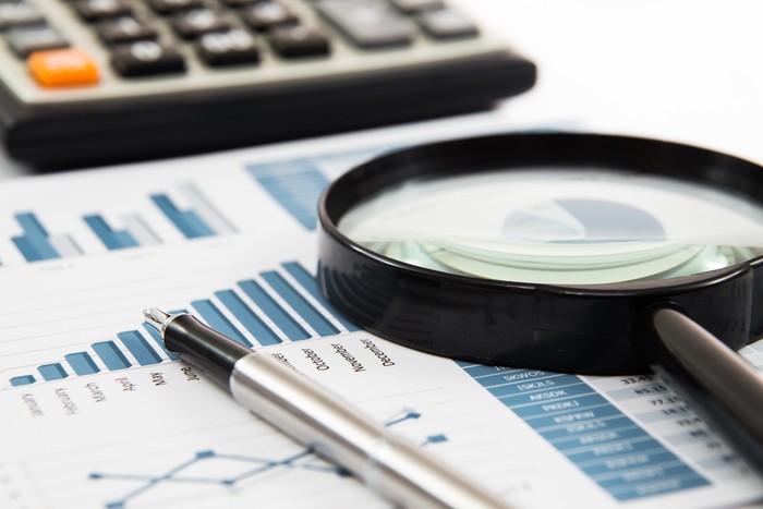 Magnifying Glass on Blue Financial Report