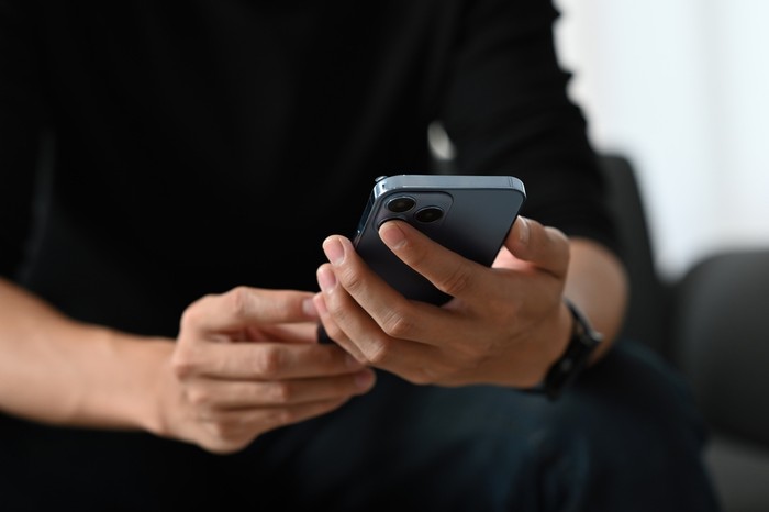 Man Wearing Black Holding Phone
