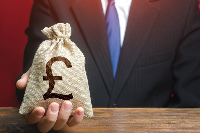 Man in Suit with GBP Money Bag