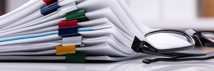 Stack of Reports with Glasses