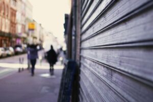 Closed Shop Shutters on Blurred High Street