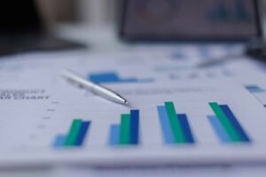 Silver Pen with Blurred Financial Charts